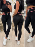 Czarne legginsy Playboy Push Up z wysokim stanem i różowym pasem modelującym sylwetkę oraz podkreślającym pośladki.